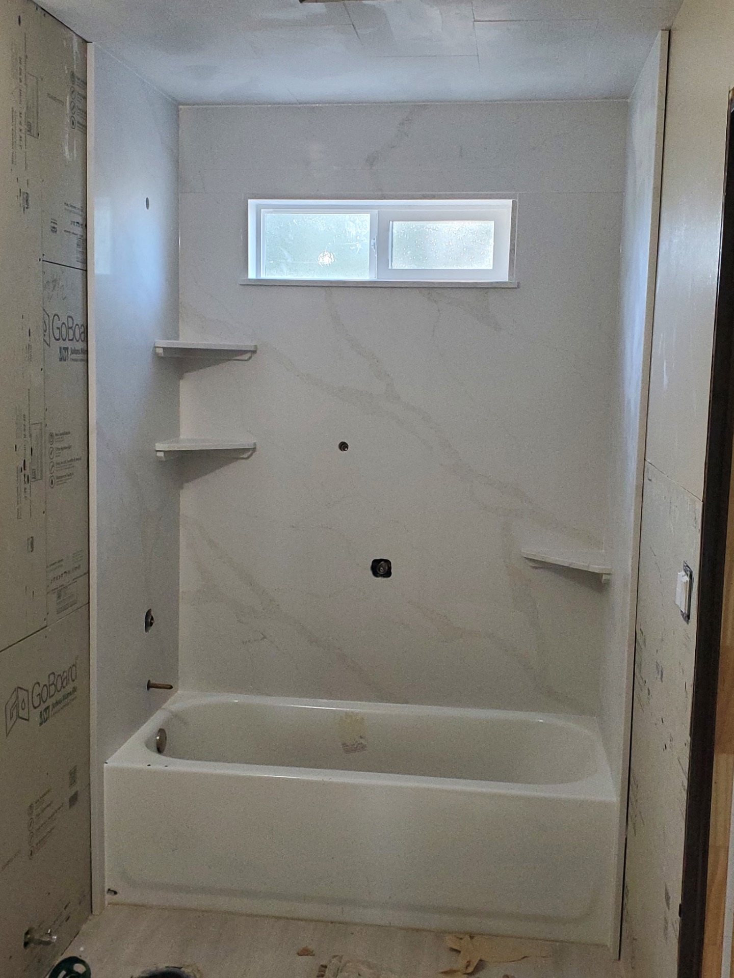 Shower surround being installed in a bathroom remodel