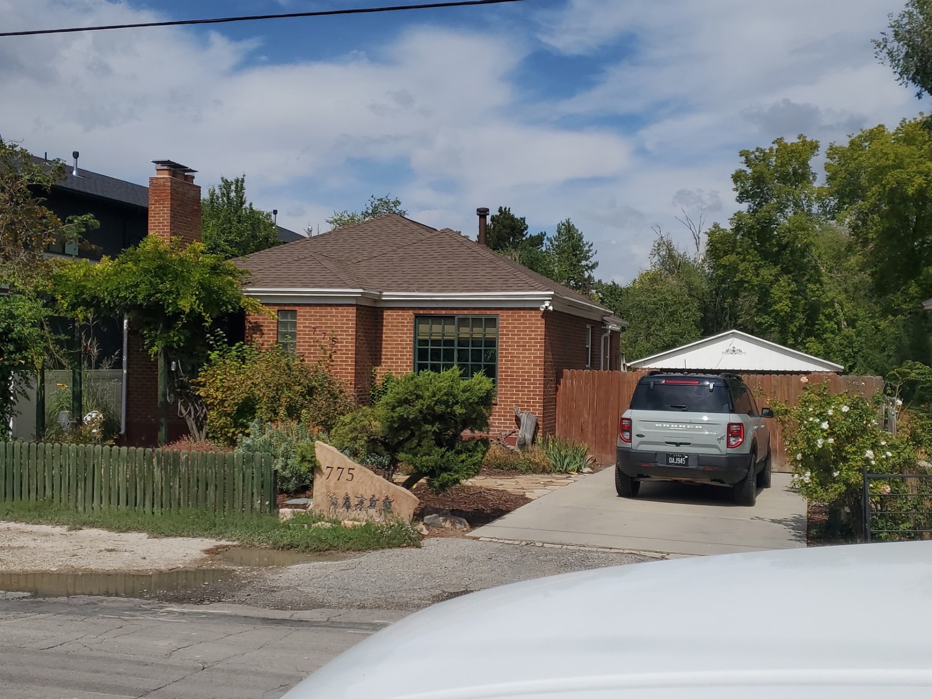 Brick home with a new brown shingle roof